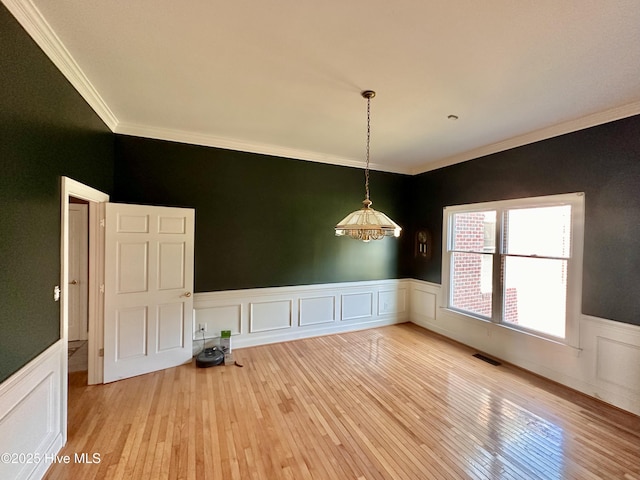 141 Baybreeze Dr, Shiloh, NC 27974 - unfurnished room with ornamental molding, wainscoting, light wood finished floors, and a decorative wall