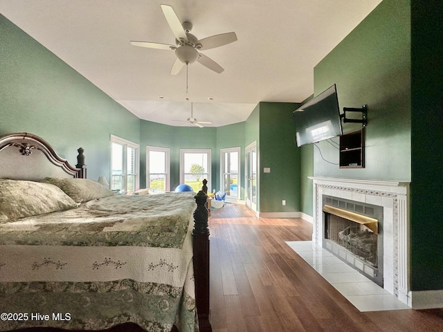 141 Baybreeze Dr, Shiloh, NC 27974 - bedroom featuring wood finished floors, a fireplace, baseboards, and a ceiling fan