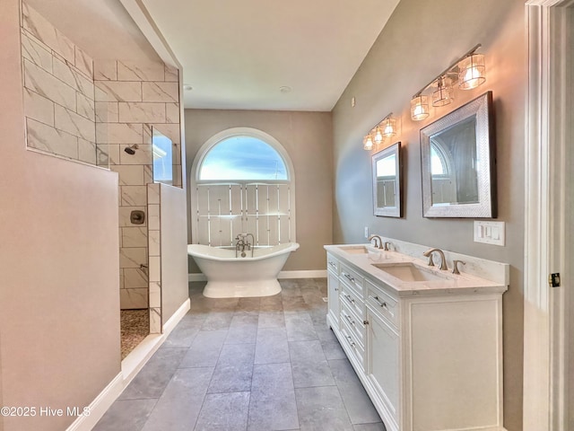 141 Baybreeze Dr, Shiloh, NC 27974 - bathroom with a freestanding tub, a walk in shower, double vanity, and baseboards