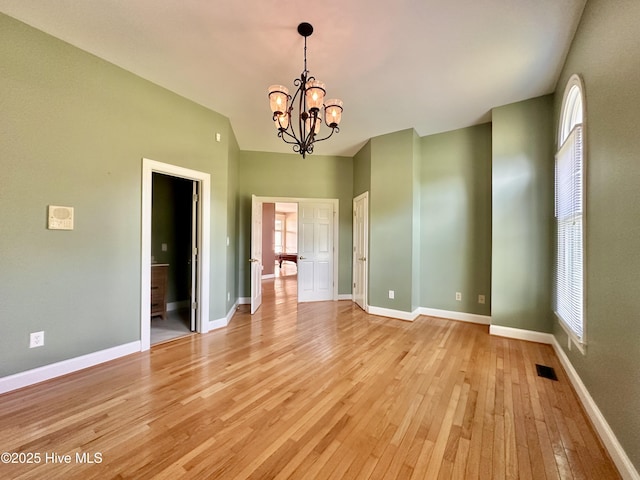 141 Baybreeze Dr, Shiloh, NC 27974 - empty room featuring light wood-style flooring, a chandelier, plenty of natural light, and baseboards