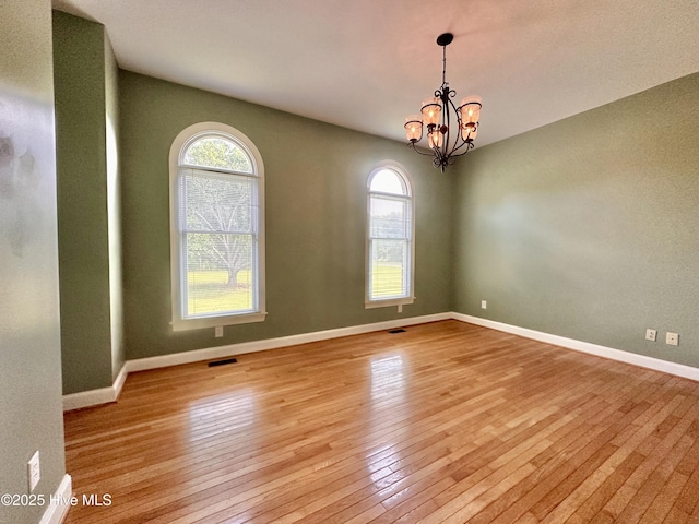 141 Baybreeze Dr, Shiloh, NC 27974 - empty room with light wood-style flooring, plenty of natural light, a chandelier, and baseboards