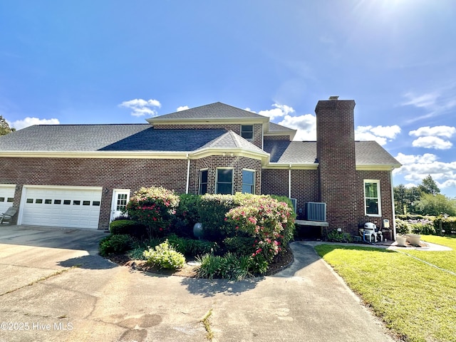 141 Baybreeze Dr, Shiloh, NC 27974 - view of front of house with driveway, brick siding, a chimney, a front lawn, and a garage