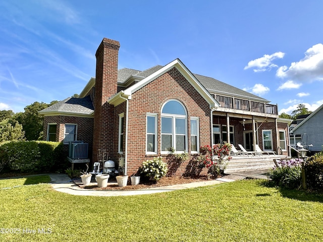 141 Baybreeze Dr, Shiloh, NC 27974 - rear view of property featuring brick siding, a chimney, a lawn, and a balcony