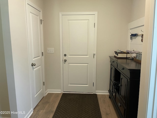 213 Woodsrun St, Raeford, NC 28376 - laundry area with dark wood-type flooring and baseboards