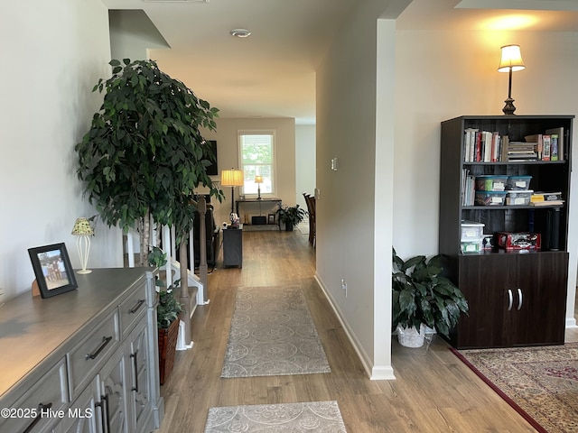 213 Woodsrun St, Raeford, NC 28376 - hallway featuring wood finished floors, arched walkways, and baseboards