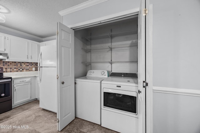114 Maid Marian Ln, Washington, NC 27889 - laundry room with separate washer and dryer, a textured ceiling, and ornamental molding