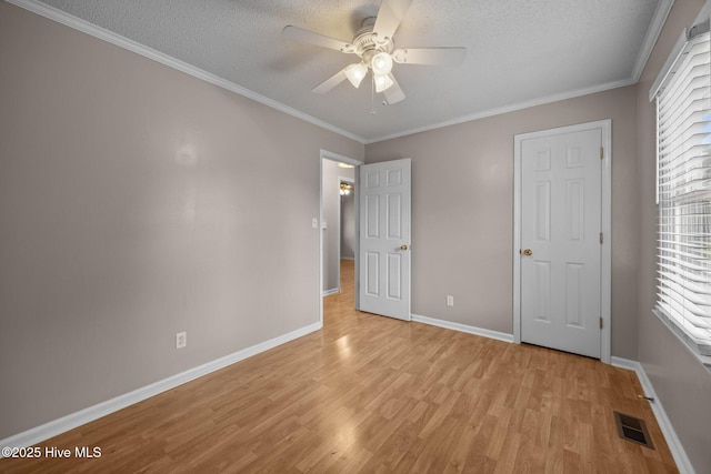 114 Maid Marian Ln, Washington, NC 27889 - unfurnished bedroom with light wood finished floors, a textured ceiling, ornamental molding, and a ceiling fan