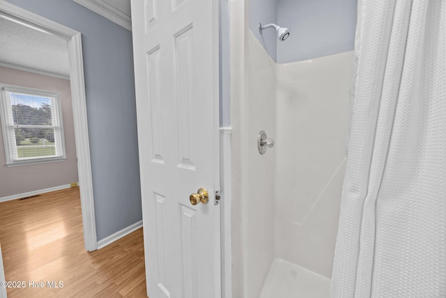 114 Maid Marian Ln, Washington, NC 27889 - bathroom featuring a shower with shower curtain, wood finished floors, and crown molding
