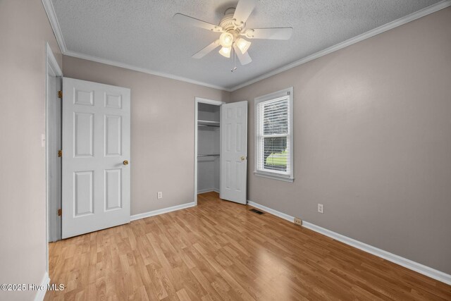 114 Maid Marian Ln, Washington, NC 27889 - unfurnished bedroom with light wood finished floors, a textured ceiling, a closet, crown molding, and ceiling fan