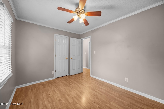 114 Maid Marian Ln, Washington, NC 27889 - unfurnished bedroom featuring light wood-style flooring, crown molding, ceiling fan, and a textured ceiling