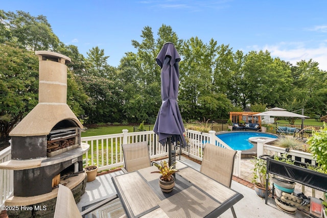 2221 Greaves Ct, Winterville, NC 28590 - view of patio / terrace with an outdoor fireplace, view of wooded area, and outdoor dining area