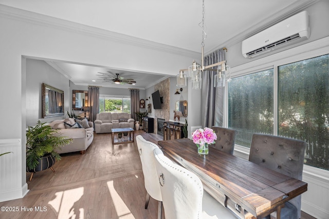 2221 Greaves Ct, Winterville, NC 28590 - dining space featuring a wall mounted AC, ornamental molding, wood finished floors, a ceiling fan, and wainscoting