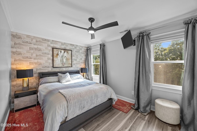 2221 Greaves Ct, Winterville, NC 28590 - bedroom featuring an accent wall, wood finished floors, crown molding, and a ceiling fan
