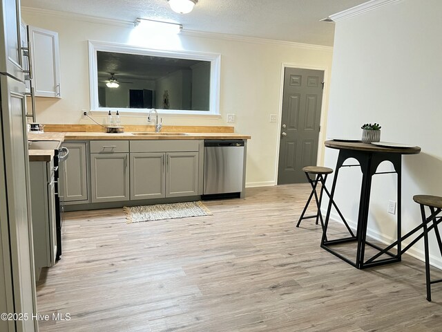 417 S Herman St, Goldsboro, NC 27530 - kitchen with dishwasher, ornamental molding, a sink, light wood finished floors, and ceiling fan