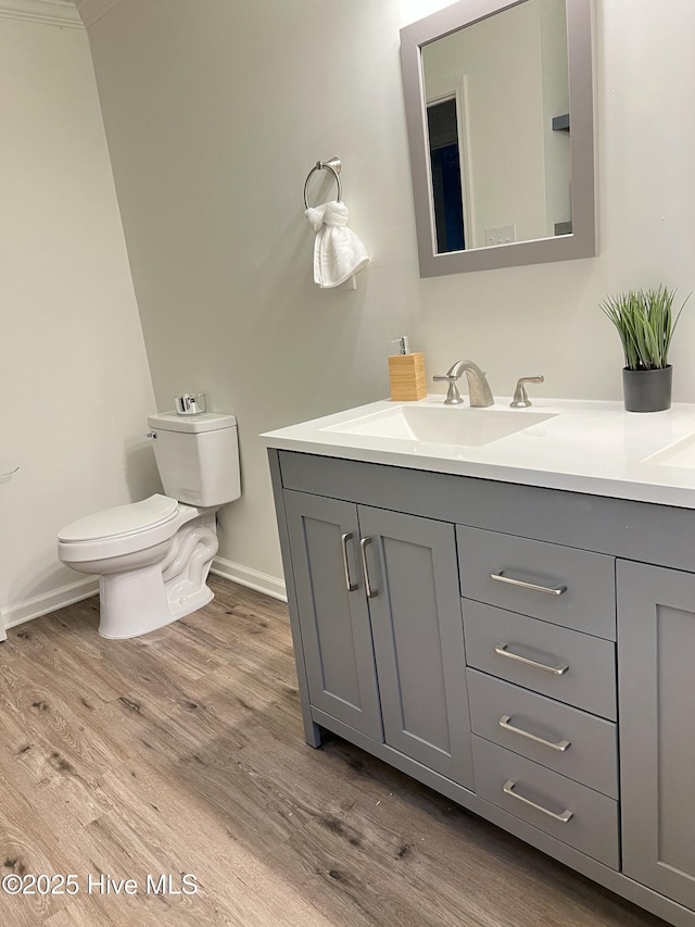 417 S Herman St, Goldsboro, NC 27530 - bathroom featuring toilet, wood finished floors, vanity, and baseboards