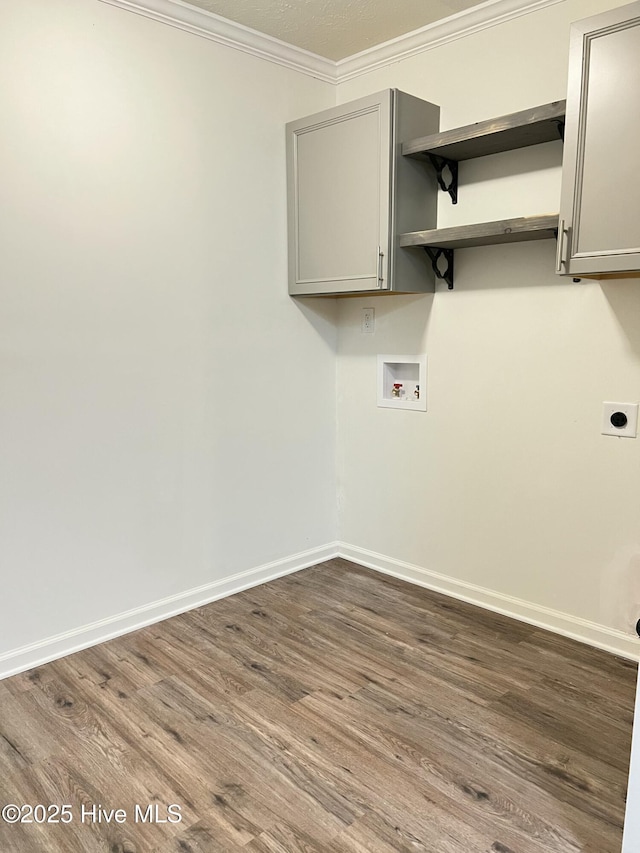 417 S Herman St, Goldsboro, NC 27530 - laundry area featuring cabinet space, hookup for an electric dryer, ornamental molding, washer hookup, and dark wood-style floors