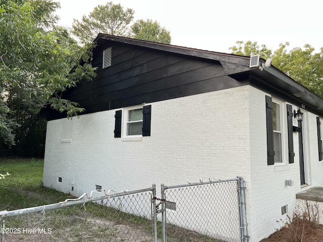 417 S Herman St, Goldsboro, NC 27530 - view of side of home featuring crawl space, brick siding, and a gate
