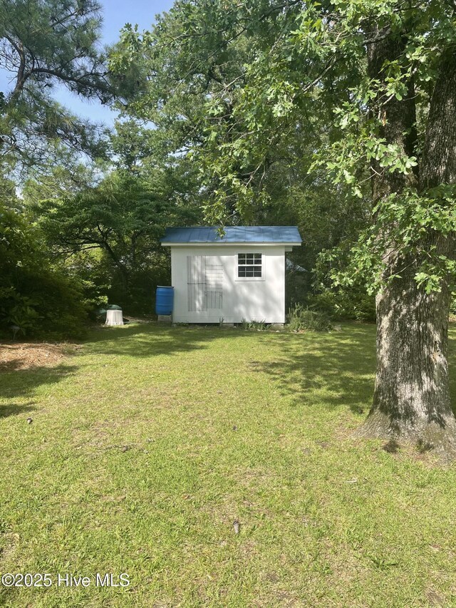 958 Holly Rd, Lakeview, NC 28350 - view of grassy yard featuring a storage unit
