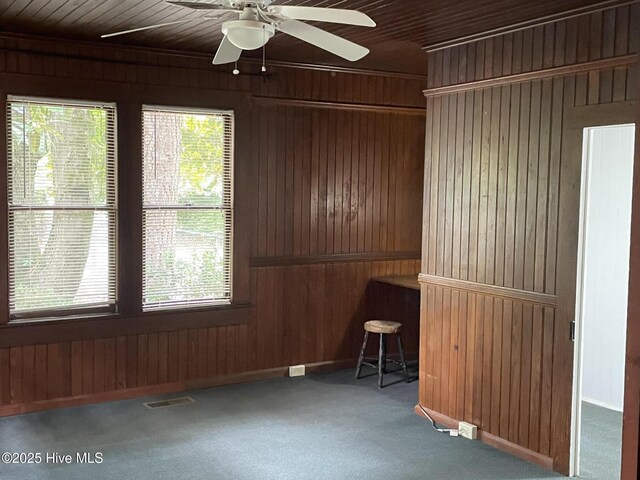 958 Holly Rd, Lakeview, NC 28350 - carpeted empty room with wood walls and a ceiling fan
