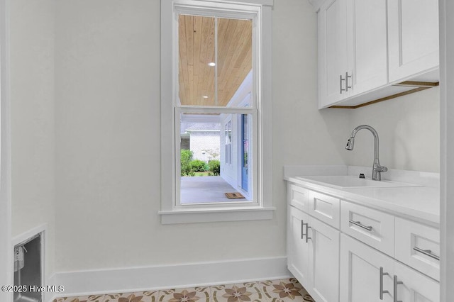 8249 Sage Valley Dr, Wilmington, NC 28411 - laundry area featuring baseboards and a sink
