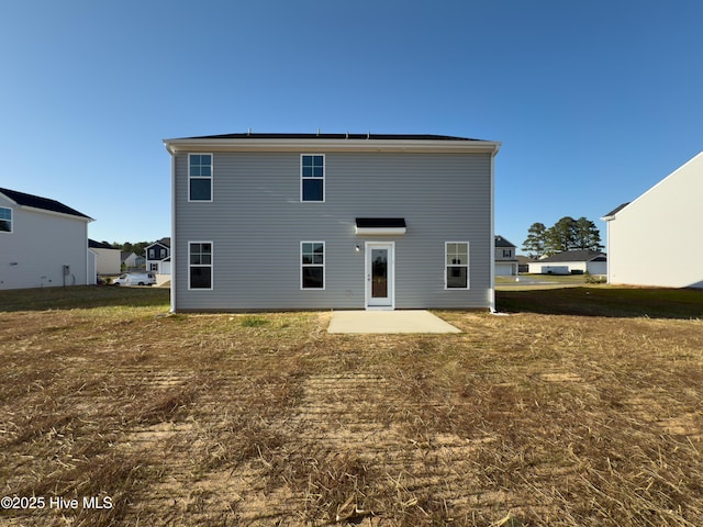 2215 Roadster Pony Ln, Hope Mills, NC 28348 - rear view of house with a patio area and a yard