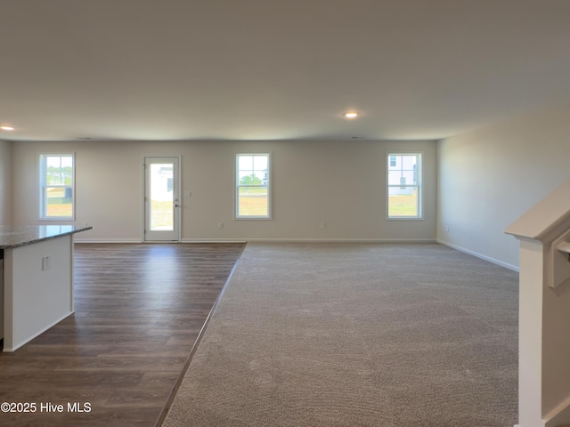 2215 Roadster Pony Ln, Hope Mills, NC 28348 - unfurnished living room with recessed lighting, plenty of natural light, baseboards, and dark wood-style floors