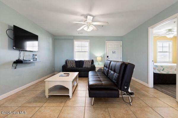 1505 N New River Dr Unit 210, Surf City, NC 28445 - living room with a ceiling fan, plenty of natural light, light tile patterned floors, and baseboards