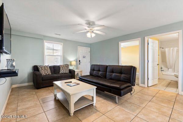 1505 N New River Dr Unit 210, Surf City, NC 28445 - living area with light tile patterned floors, a ceiling fan, and baseboards
