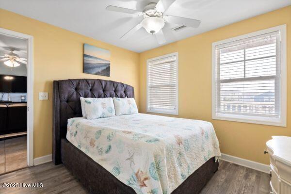 1505 N New River Dr Unit 210, Surf City, NC 28445 - bedroom with wood finished floors, baseboards, and a ceiling fan