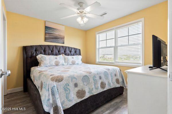 1505 N New River Dr Unit 210, Surf City, NC 28445 - bedroom featuring baseboards, wood finished floors, and a ceiling fan