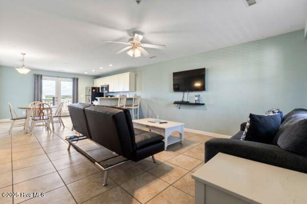 1505 N New River Dr Unit 210, Surf City, NC 28445 - living area featuring ceiling fan, light tile patterned flooring, and baseboards