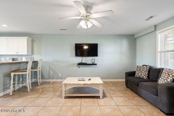 1505 N New River Dr Unit 210, Surf City, NC 28445 - living room with light tile patterned floors, a ceiling fan, and baseboards