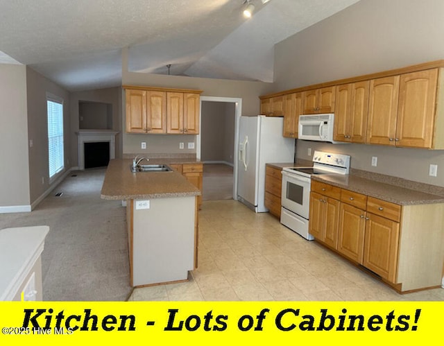 12 Deerwood Ln, Pinehurst, NC 28374 - kitchen featuring white appliances, vaulted ceiling, a sink, light countertops, and baseboards