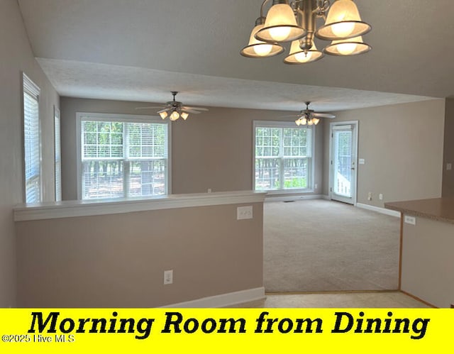 12 Deerwood Ln, Pinehurst, NC 28374 - kitchen with ceiling fan, baseboards, light carpet, a chandelier, and a textured ceiling