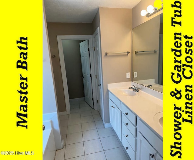 12 Deerwood Ln, Pinehurst, NC 28374 - full bathroom featuring double vanity, tile patterned flooring, a bath, and baseboards