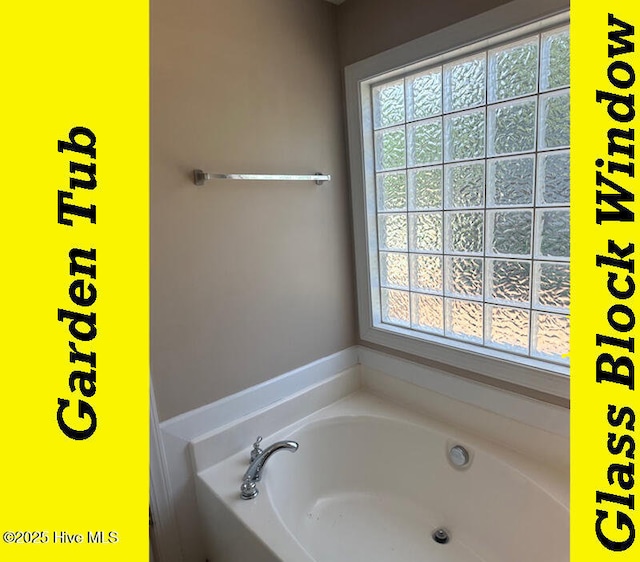 12 Deerwood Ln, Pinehurst, NC 28374 - bathroom featuring healthy amount of natural light and a bath