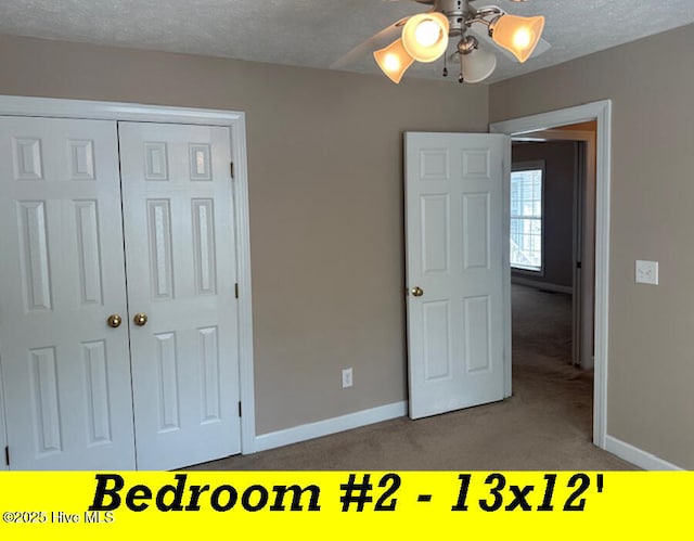 12 Deerwood Ln, Pinehurst, NC 28374 - unfurnished bedroom featuring carpet flooring, a textured ceiling, a closet, and baseboards