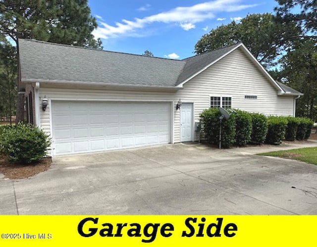 12 Deerwood Ln, Pinehurst, NC 28374 - view of front of home featuring a garage, driveway, and a shingled roof