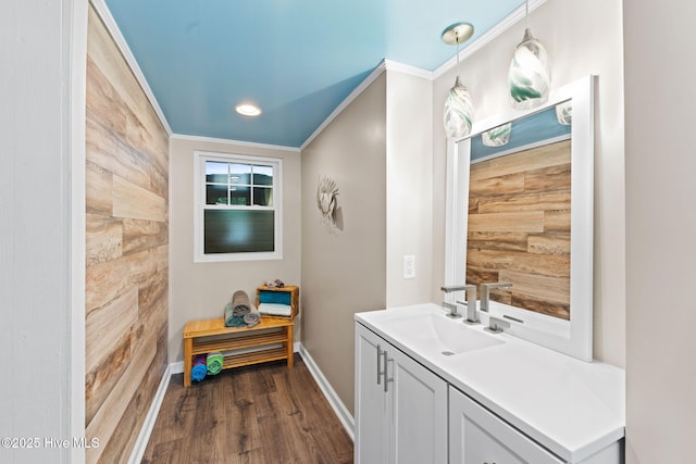 115 NE 66th St, Oak Island, NC 28465 - bathroom featuring vanity, baseboards, wood finished floors, ornamental molding, and recessed lighting