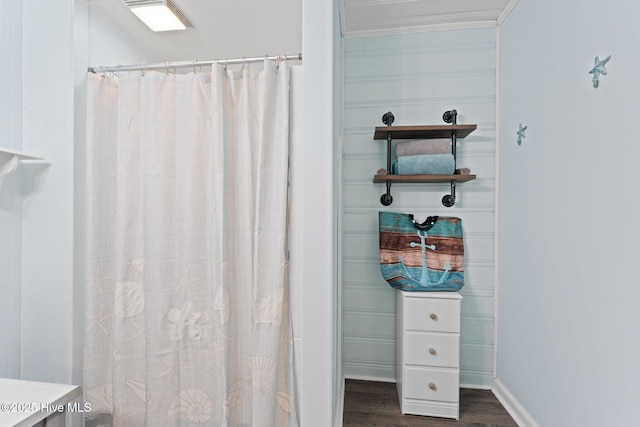 115 NE 66th St, Oak Island, NC 28465 - bathroom featuring wood finished floors, a shower with curtain, baseboards, and ornamental molding