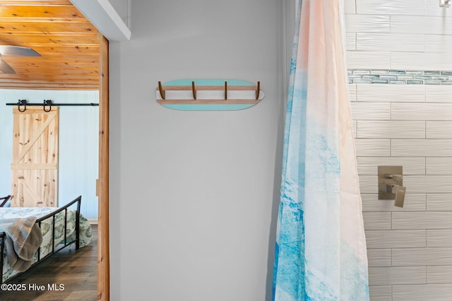 115 NE 66th St, Oak Island, NC 28465 - full bathroom with a shower with curtain and wood finished floors