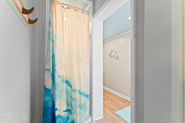 115 NE 66th St, Oak Island, NC 28465 - bathroom with wood finished floors, baseboards, and a shower with curtain