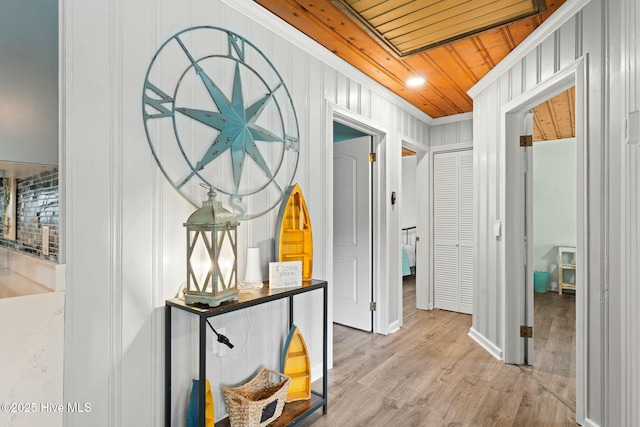 115 NE 66th St, Oak Island, NC 28465 - corridor featuring ornamental molding, wood finished floors, wooden ceiling, a decorative wall, and baseboards