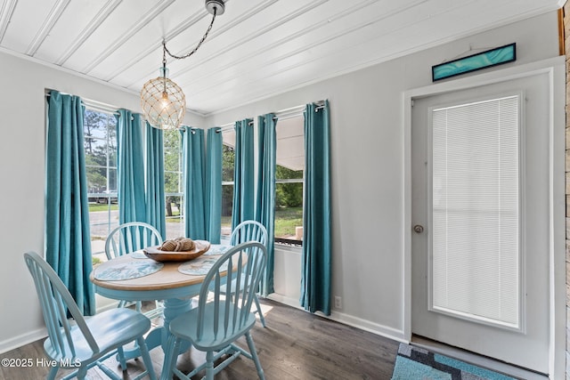 115 NE 66th St, Oak Island, NC 28465 - dining space featuring baseboards and dark wood-style floors