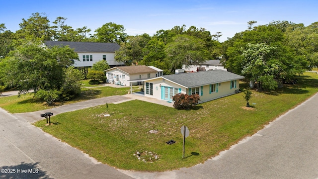 115 NE 66th St, Oak Island, NC 28465 - view of front of house featuring driveway and a front yard