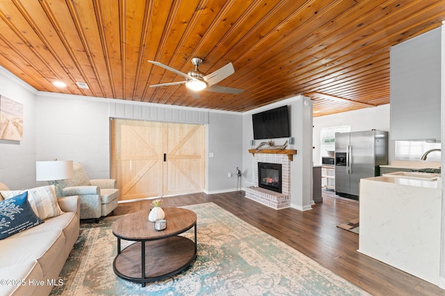 115 NE 66th St, Oak Island, NC 28465 - living area featuring wood ceiling, ceiling fan, dark wood-style flooring, a fireplace, and ornamental molding