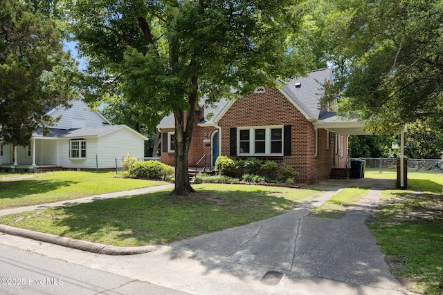 1208 N Bonner St, Washington, NC 27889 - view of front of home featuring brick siding, driveway, and an attached carport