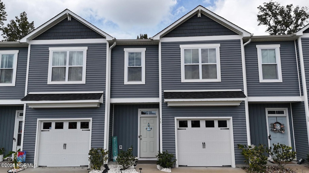 11 Acacia Rd, Hampstead, NC 28443 - townhome / multi-family property with an attached garage and concrete driveway