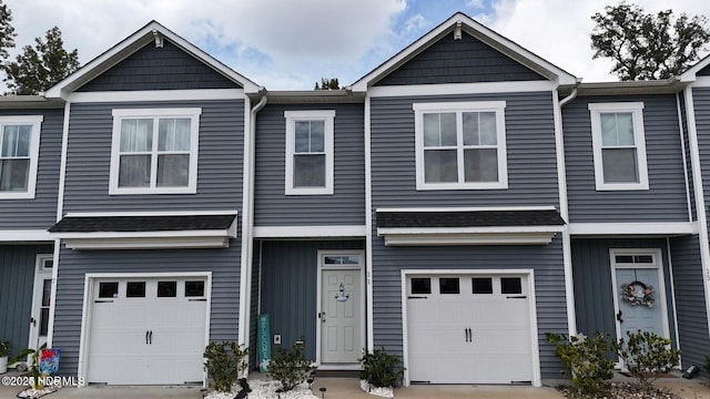 11 Acacia Rd, Hampstead, NC 28443 - townhome / multi-family property with an attached garage and concrete driveway