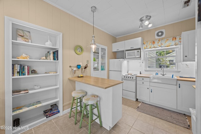 215C Battleground Ave, New Bern, NC 28560 - kitchen with white appliances, crown molding, light tile patterned floors, white cabinetry, and hanging light fixtures